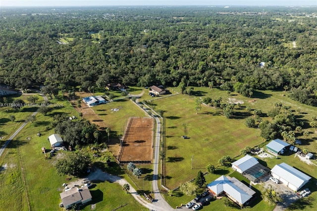 birds eye view of property featuring a forest view