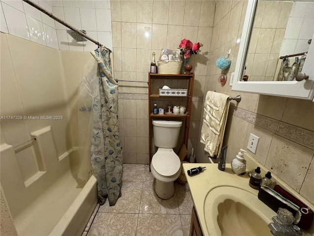 full bath featuring toilet, vanity, tile patterned flooring, and tile walls