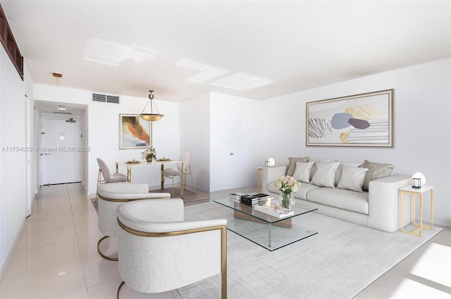 living room featuring light tile patterned floors and visible vents