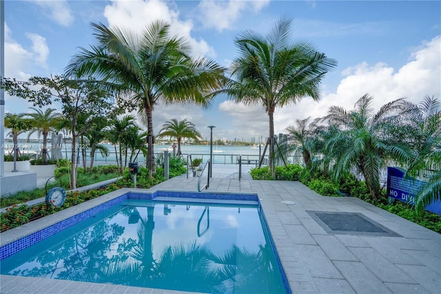 outdoor pool featuring a patio area and fence