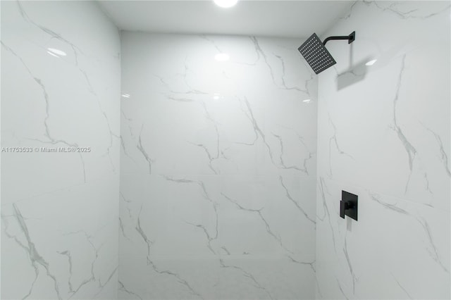 room details featuring a marble finish shower