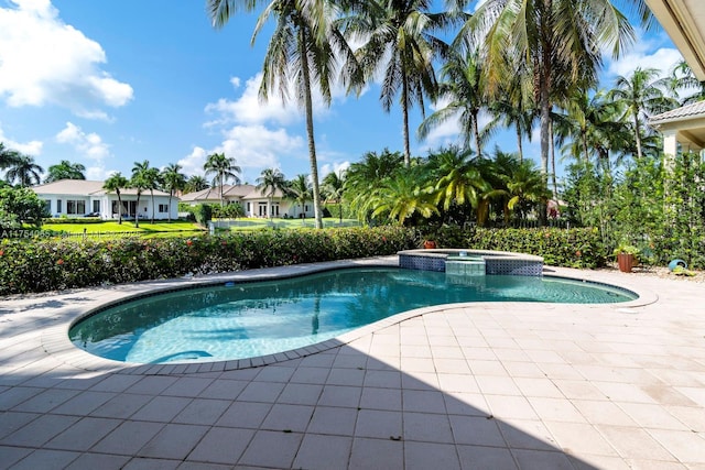 view of pool with a pool with connected hot tub and a patio area