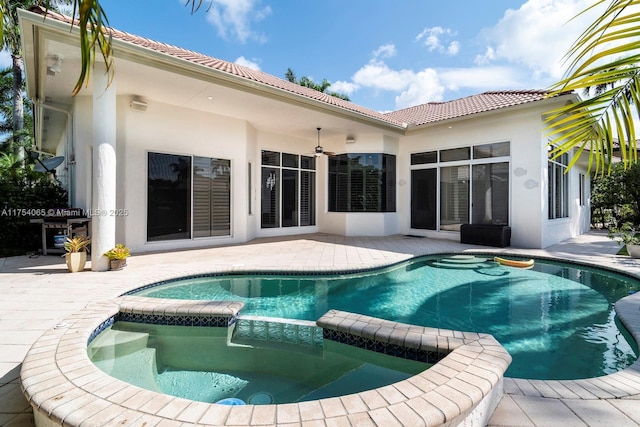 view of swimming pool with a patio and a pool with connected hot tub