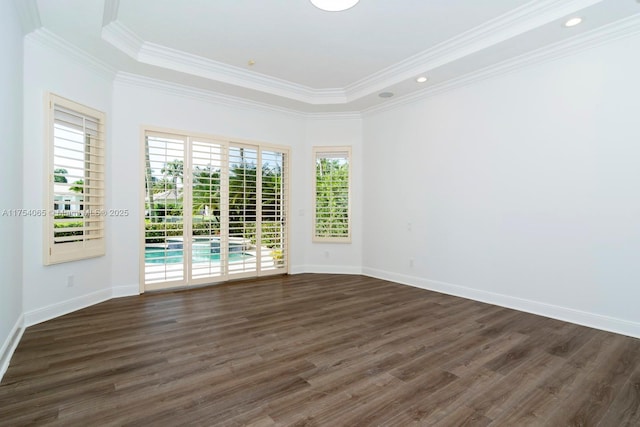 empty room with baseboards, ornamental molding, and dark wood finished floors