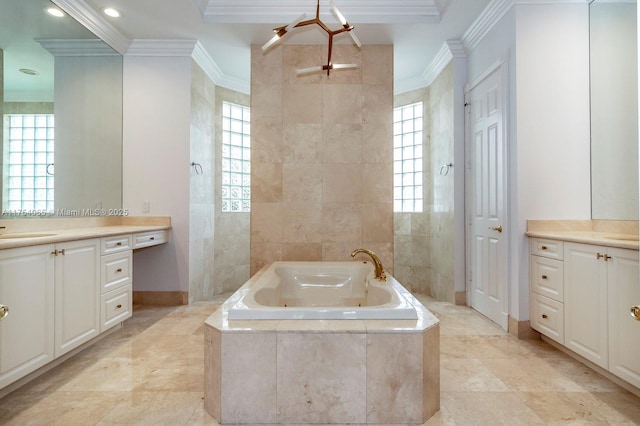 full bathroom with tile walls, baseboards, ornamental molding, vanity, and a jetted tub