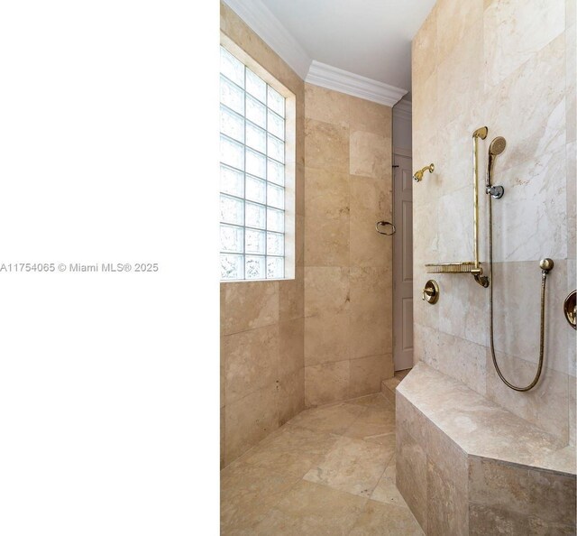 full bath featuring a tile shower and crown molding