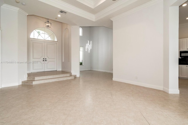 entrance foyer with light tile patterned flooring, visible vents, crown molding, baseboards, and a towering ceiling