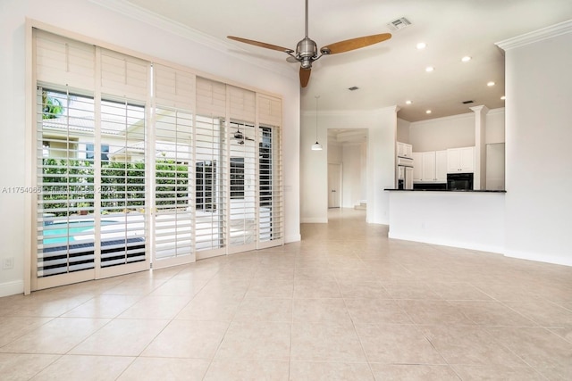 unfurnished living room with crown molding, light tile patterned floors, baseboards, ceiling fan, and visible vents