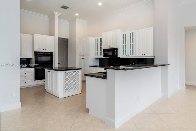 kitchen featuring decorative backsplash, black appliances, glass insert cabinets, and visible vents