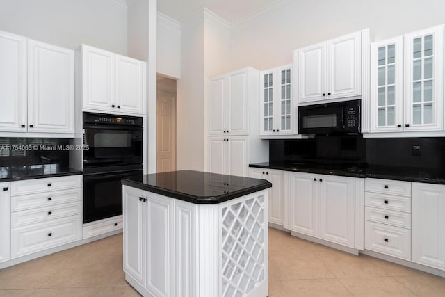 kitchen featuring light tile patterned floors, dark countertops, and black appliances