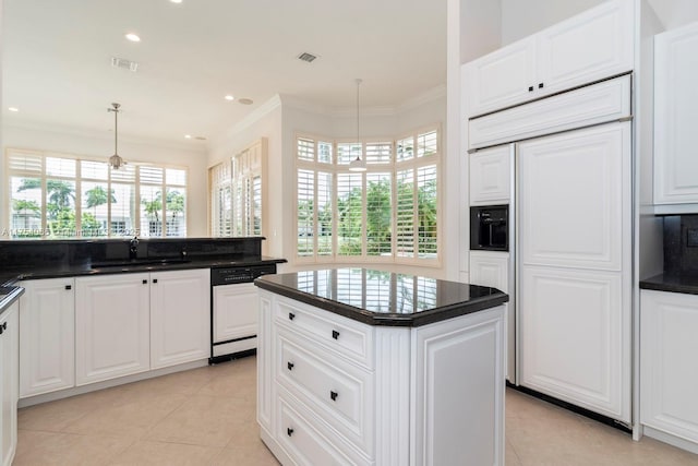 kitchen featuring a sink, paneled appliances, visible vents, dark countertops, and ornamental molding