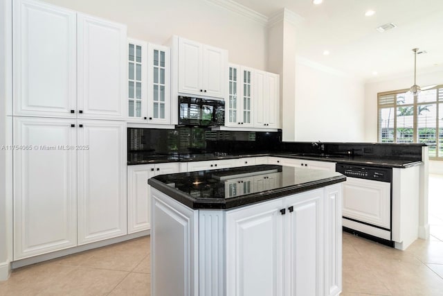 kitchen featuring visible vents, a peninsula, ornamental molding, a sink, and black appliances