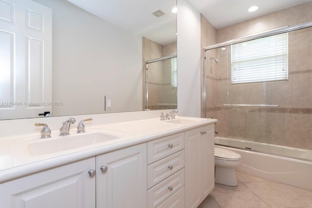 bathroom with visible vents, toilet, tile patterned flooring, and a sink
