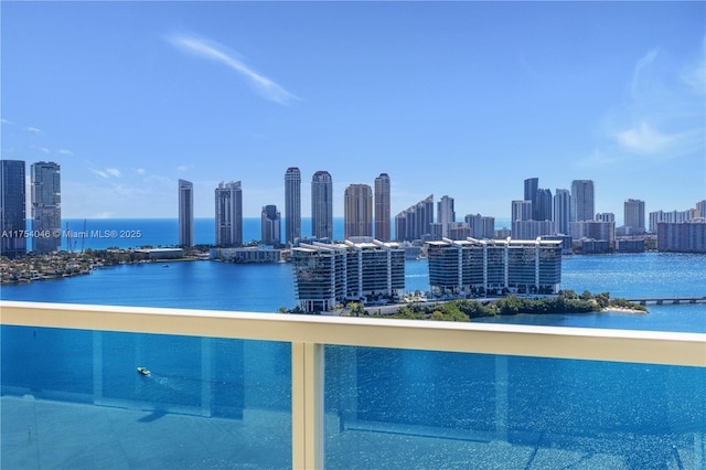 view of pool with a view of city and a water view