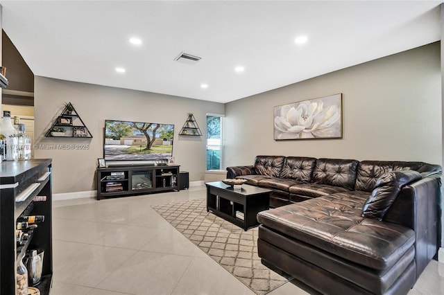 living room with recessed lighting, visible vents, baseboards, and light tile patterned floors