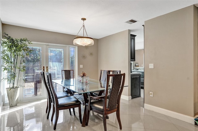 dining space featuring baseboards, visible vents, and french doors