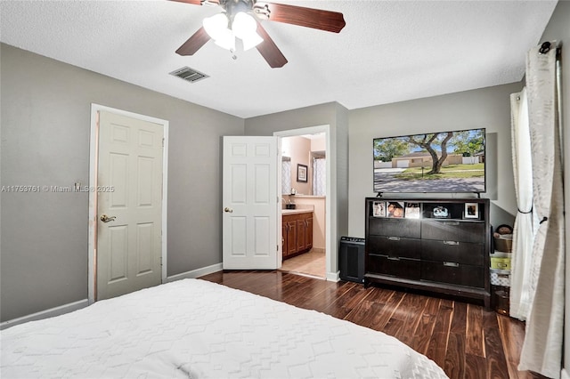 bedroom with baseboards, visible vents, connected bathroom, ceiling fan, and dark wood-type flooring