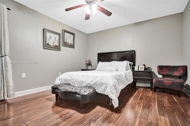 bedroom with a ceiling fan, baseboards, and wood finished floors