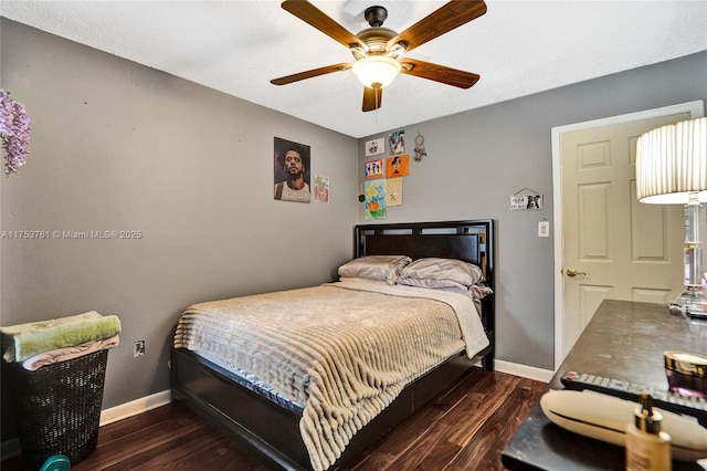 bedroom with ceiling fan, baseboards, and wood finished floors