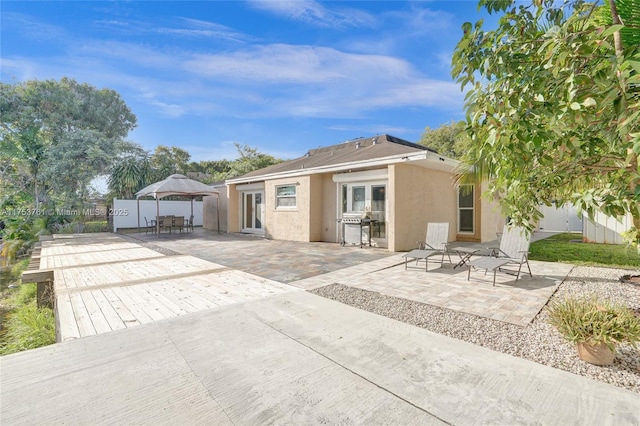 back of property featuring a patio area, french doors, and stucco siding