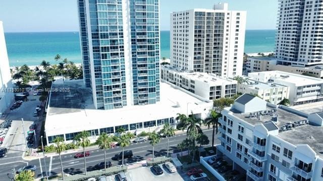 birds eye view of property with a city view and a water view