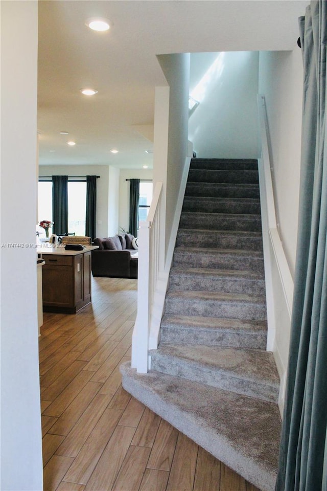 stairway featuring recessed lighting and wood finished floors