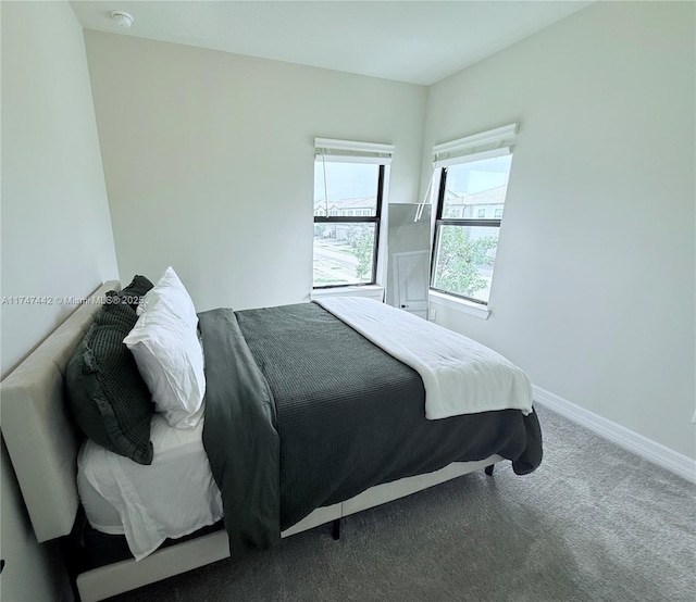 bedroom featuring carpet and baseboards