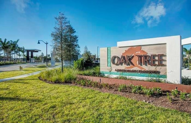 community / neighborhood sign with a lawn