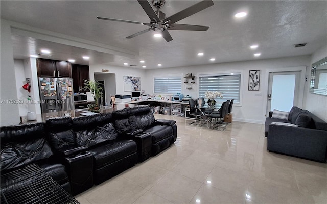 living area with ceiling fan, visible vents, baseboards, and recessed lighting