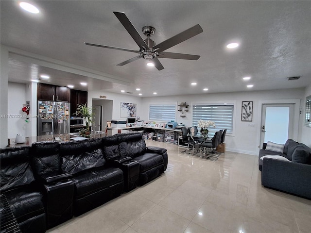 living area with a ceiling fan, visible vents, and recessed lighting