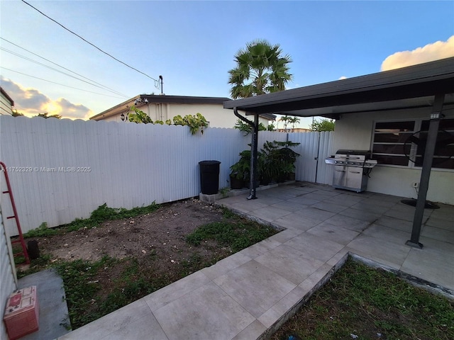 exterior space featuring a grill and fence