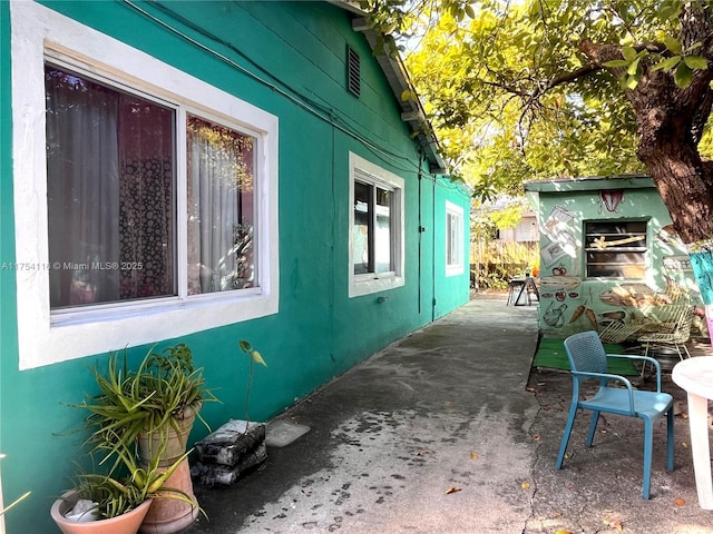 view of side of home featuring a patio area and stucco siding