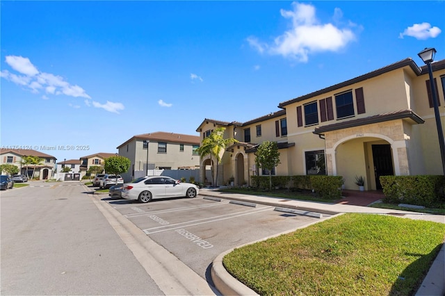 uncovered parking lot featuring a residential view