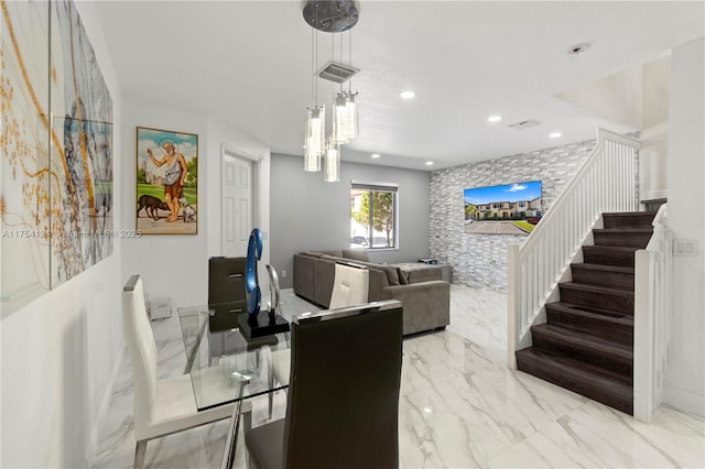 dining room featuring visible vents, an accent wall, marble finish floor, stairs, and recessed lighting