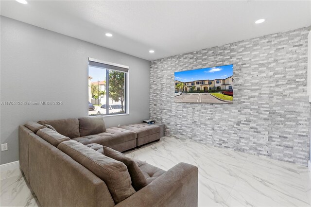 living area featuring marble finish floor and recessed lighting