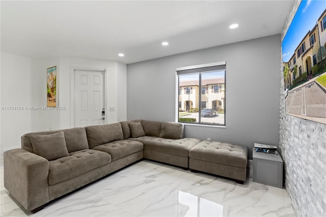 living area with recessed lighting and marble finish floor