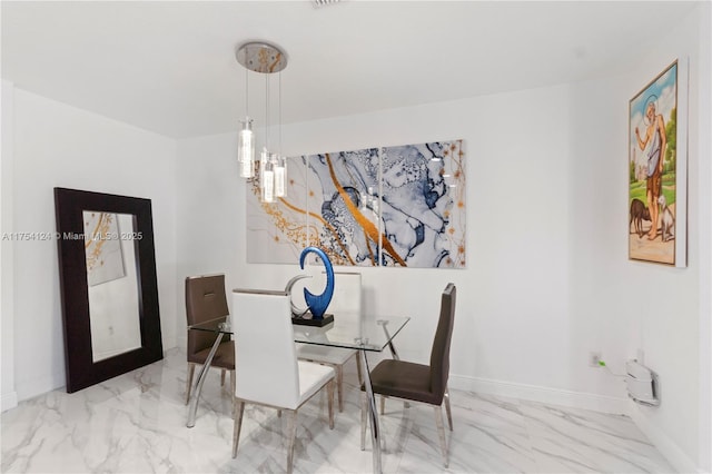 dining space featuring marble finish floor and baseboards