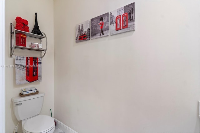 bathroom with toilet and baseboards