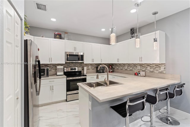 kitchen with stainless steel appliances, a breakfast bar, a sink, visible vents, and marble finish floor