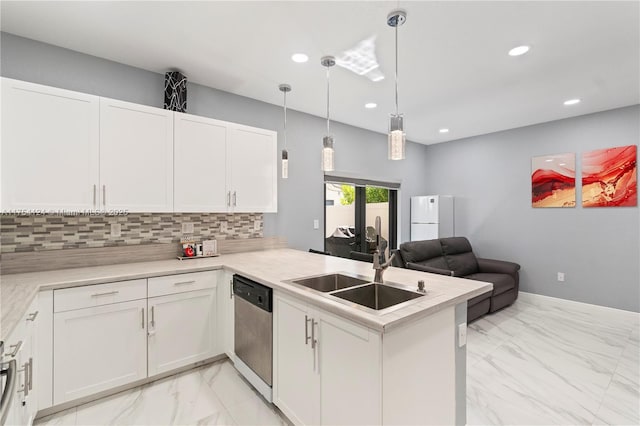 kitchen featuring decorative backsplash, stainless steel dishwasher, open floor plan, a sink, and a peninsula