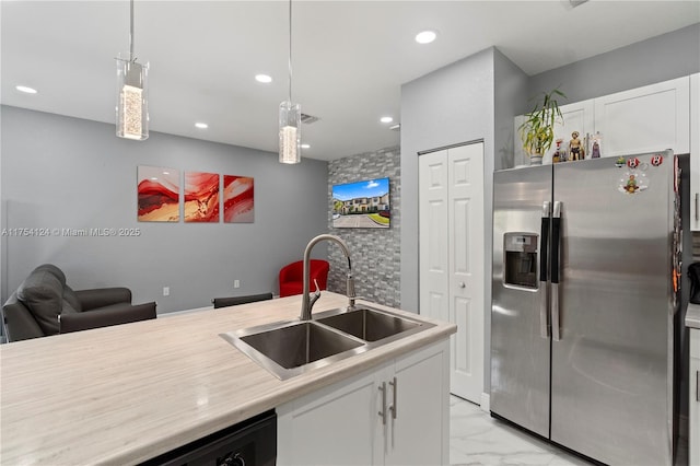 kitchen featuring marble finish floor, light countertops, white cabinetry, a sink, and stainless steel fridge with ice dispenser