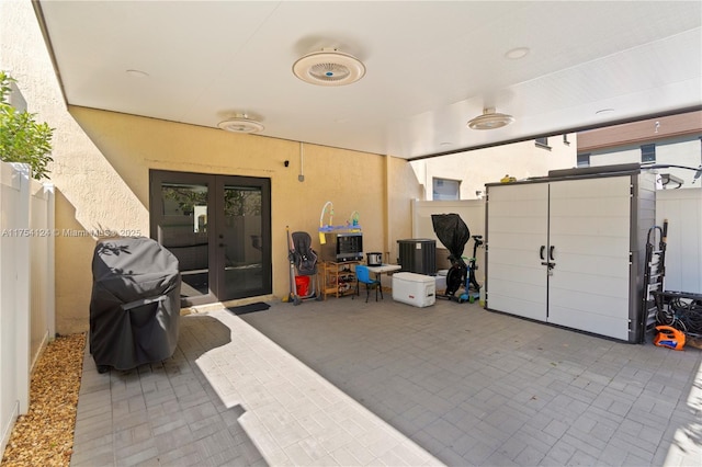 view of patio with fence, grilling area, and french doors