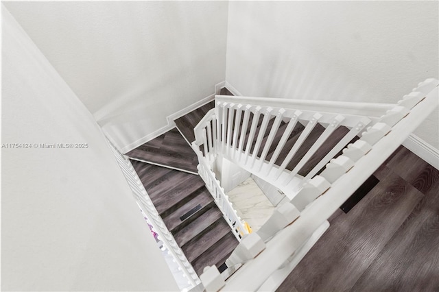 stairs featuring baseboards and wood finished floors