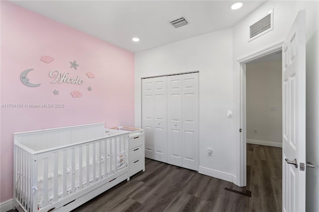 bedroom with baseboards, visible vents, and dark wood-type flooring