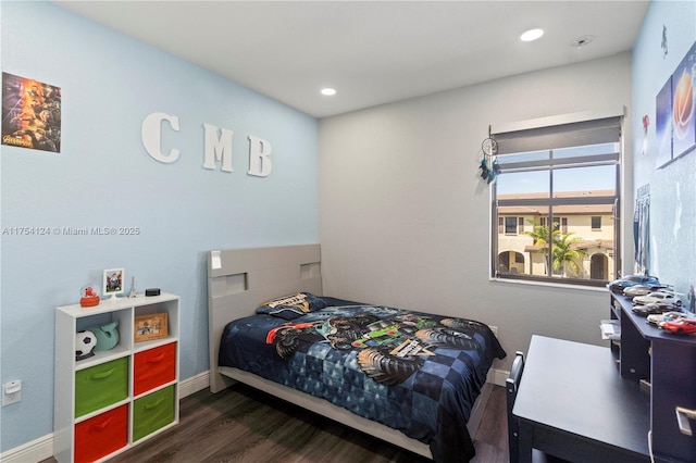 bedroom with baseboards, wood finished floors, and recessed lighting