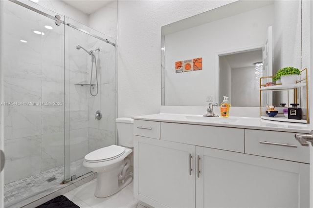 bathroom featuring a marble finish shower, vanity, and toilet