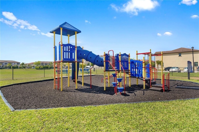 communal playground with a lawn and fence