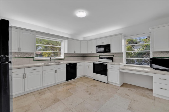 177 NE 109th St, Miami Shores, FL 33161 - kitchen with black appliances, backsplash, and healthy amount of natural light