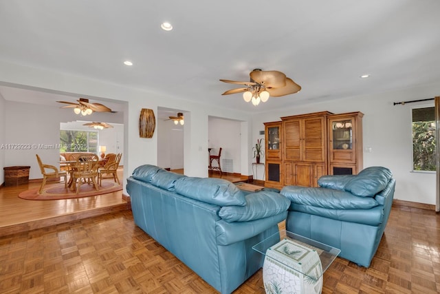 living area featuring recessed lighting, ceiling fan, and baseboards