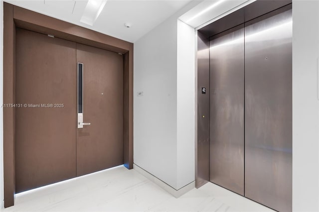 interior space featuring marble finish floor and elevator